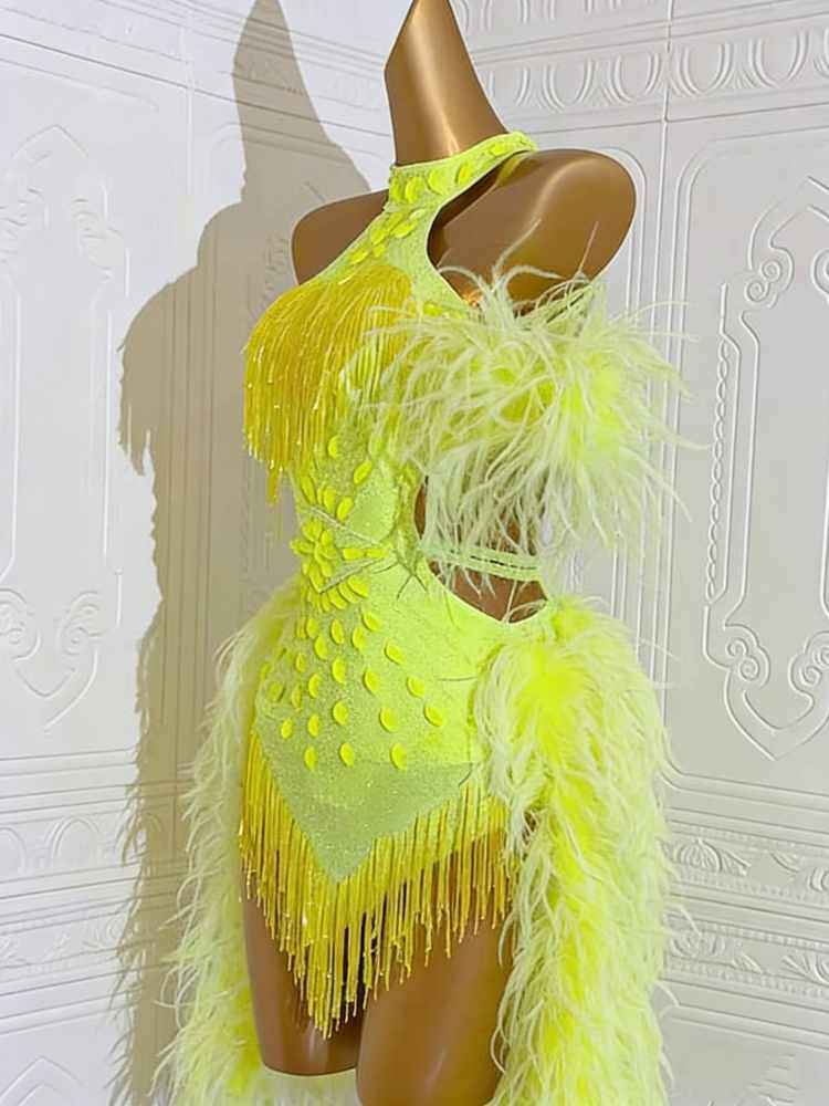 neon yellow feather dress A mini dress that radiates confidence, feather-light in texture, yet bold in presence. Neon yellow catches the spotlight, turning every step into a statement of joy and power. #AbedMahfouz #Couture